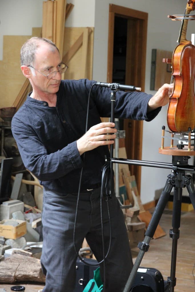 Joseph Curtin measuring a violin in his Ann Arbor workshop