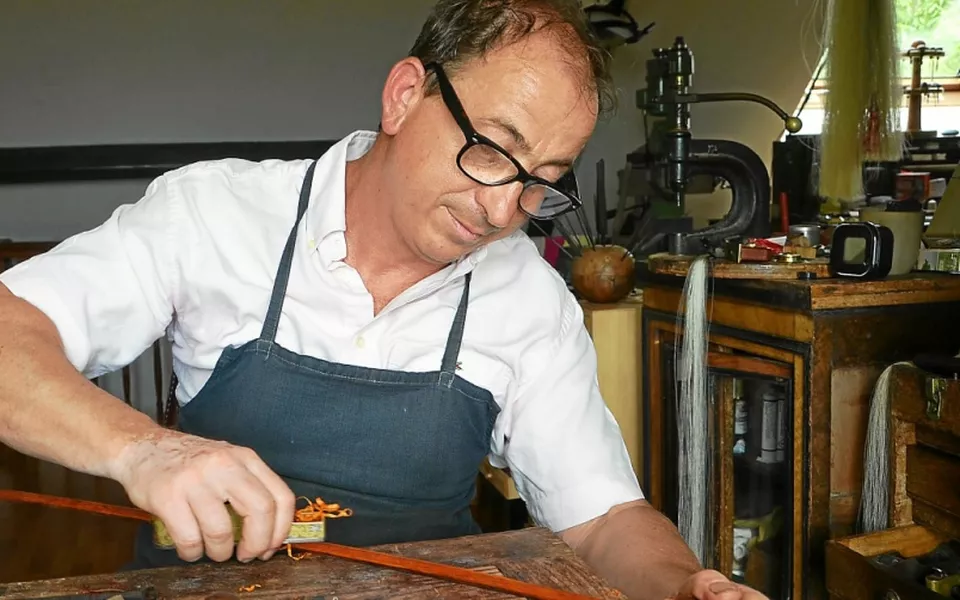 Eric Grandchamp working on a bow in his workshop